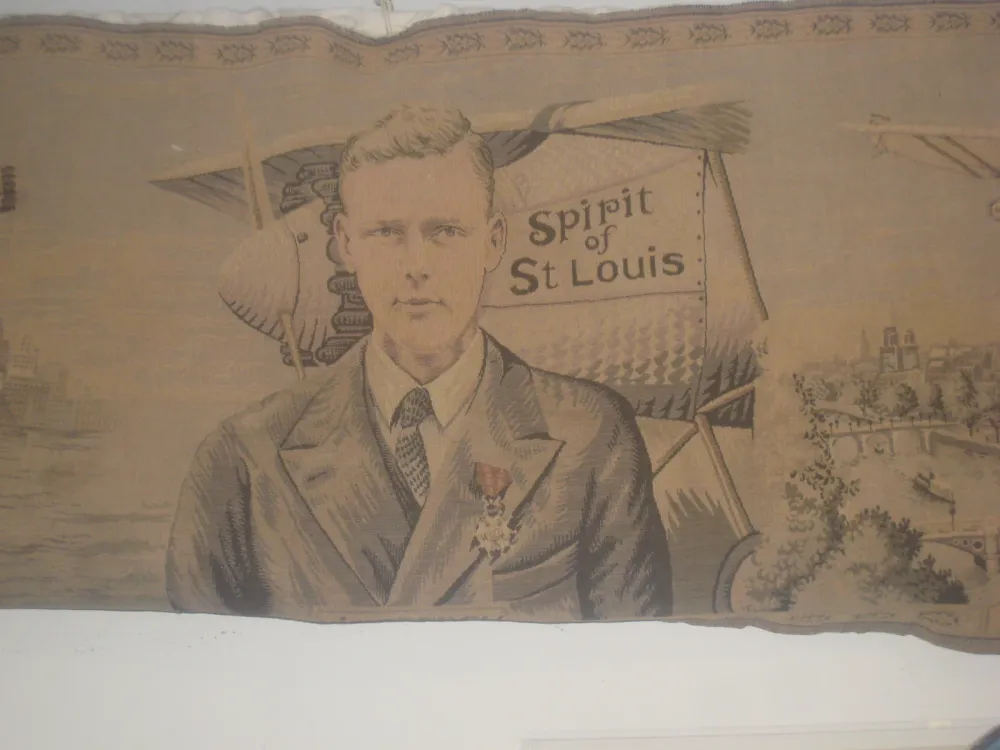 Tapestry portrait of Charles Lindbergh in front of the Spirit of St. Louis