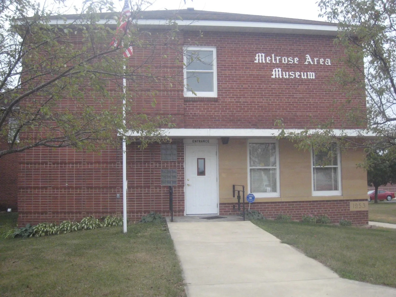 The Melrose Area Museum, a two-story brick building with a white entrance door