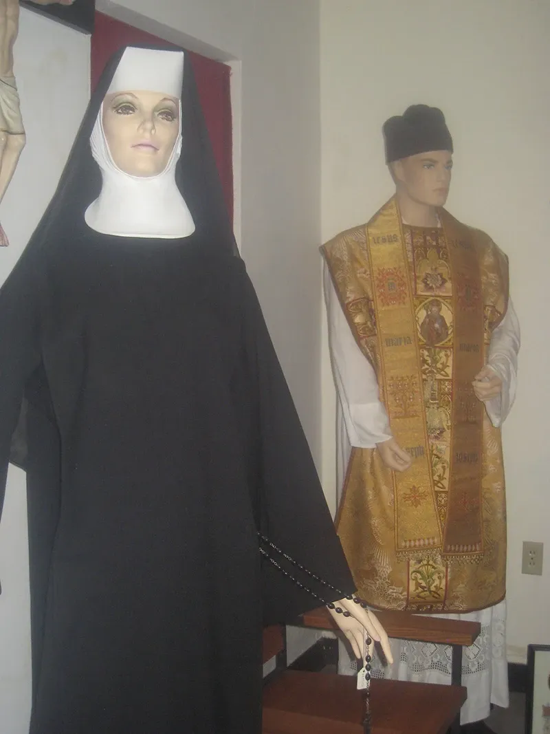 Mannequins dressed in a sister’s habit and priest’s vestments