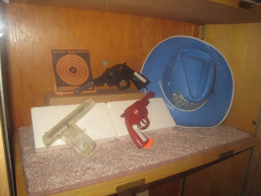 Display of toy pistols and a blue hat
